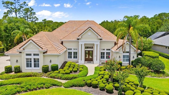 1324 Dovercourt Ln, Ormond Beach, FL 32174 - back of property with a tiled roof, french doors, and stucco siding