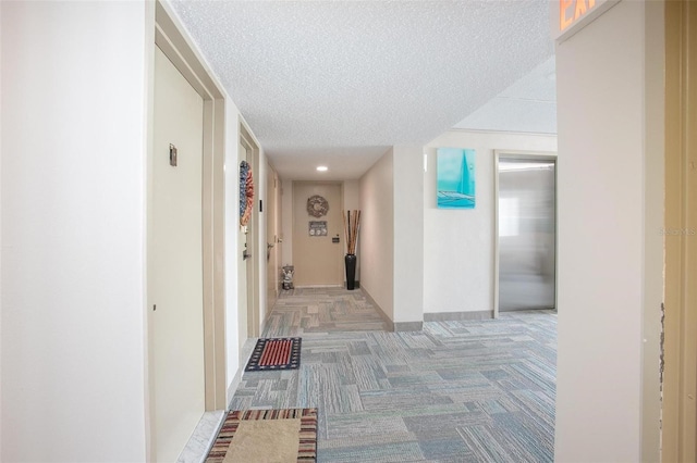 3043 S Atlantic Ave Unit 204, Daytona Beach, FL 32118 - hall with light colored carpet, a textured ceiling, baseboards, and recessed lighting