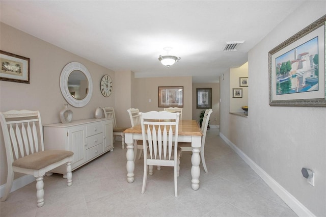 3043 S Atlantic Ave Unit 204, Daytona Beach, FL 32118 - dining area with baseboards and light tile patterned floors