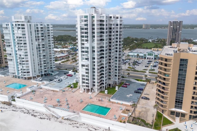 3043 S Atlantic Ave Unit 204, Daytona Beach, FL 32118 - view of urban area featuring a pool, a large body of water, and apartment complex / building