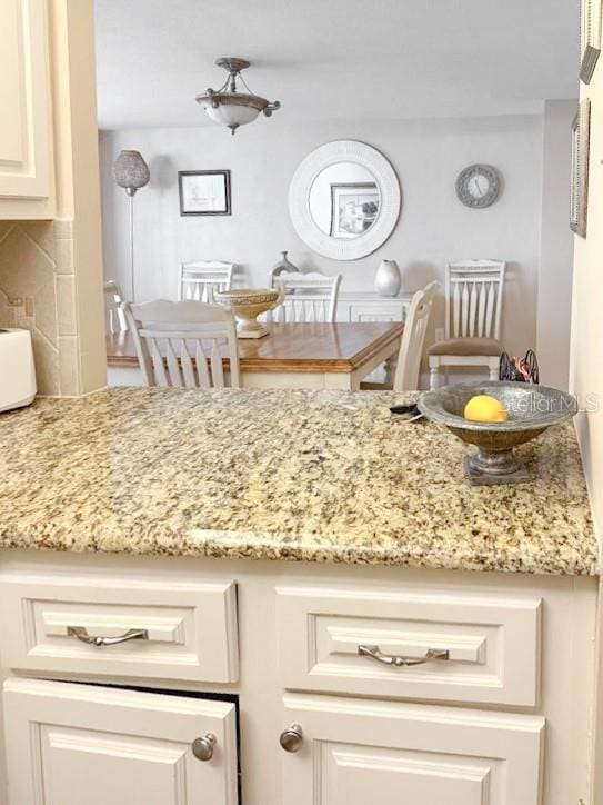 3043 S Atlantic Ave Unit 204, Daytona Beach, FL 32118 - kitchen with light stone counters and tasteful backsplash