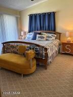 2898 Ocean Shore Blvd Unit 603, Ormond Beach, FL 32176 - bedroom with carpet floors and lofted ceiling