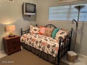 2898 Ocean Shore Blvd Unit 603, Ormond Beach, FL 32176 - bedroom featuring baseboards and light tile patterned floors