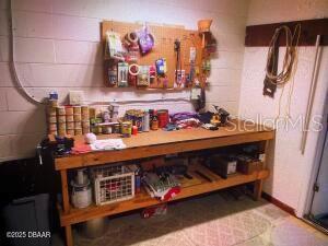 2898 Ocean Shore Blvd Unit 603, Ormond Beach, FL 32176 - bar area with concrete block wall and a workshop area