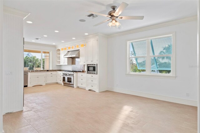 2275 Genesea Ln, Vero Beach, FL 32963 - kitchen featuring stainless steel appliances, under cabinet range hood, ornamental molding, white cabinets, and baseboards
