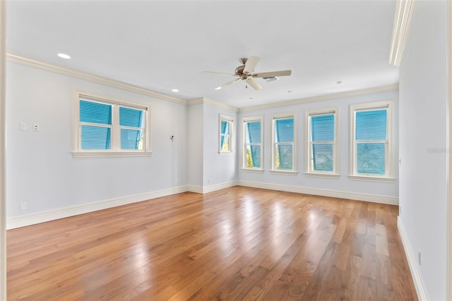 2275 Genesea Ln, Vero Beach, FL 32963 - empty room with healthy amount of natural light, light wood-style flooring, a ceiling fan, baseboards, and crown molding