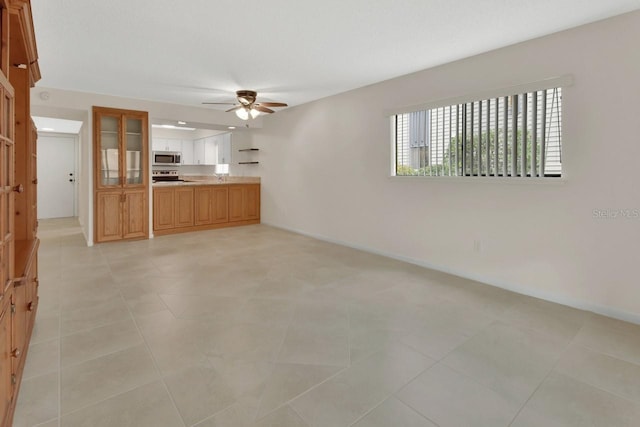 600 N Boundary Ave Unit 110A, Deland, FL 32720 - unfurnished living room with a ceiling fan and baseboards