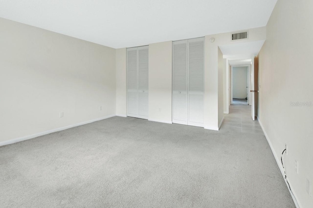 600 N Boundary Ave Unit 110A, Deland, FL 32720 - unfurnished bedroom featuring carpet, two closets, and baseboards