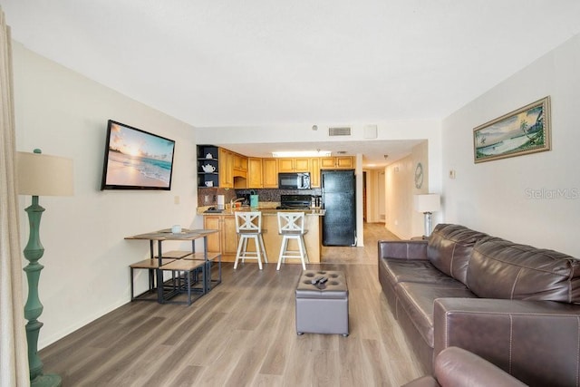 3647 S Atlantic Ave Unit 7C, Daytona Beach, FL 32118 - living room with light wood-type flooring and baseboards