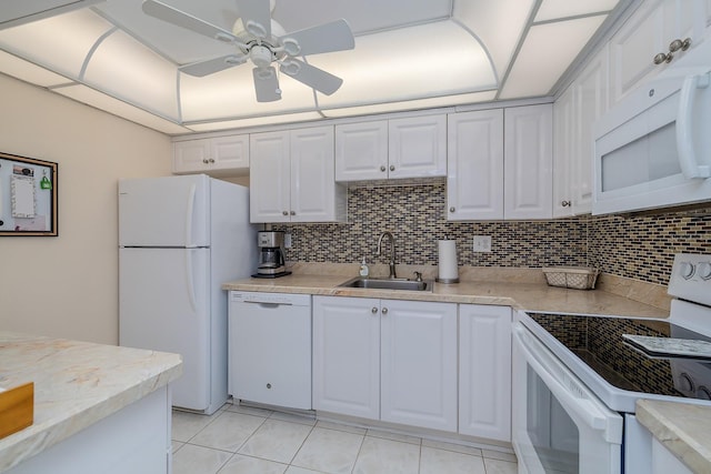 2800 N Atlantic Ave Unit 1716, Daytona Beach, FL 32118 - kitchen with white appliances, a sink, a ceiling fan, decorative backsplash, and white cabinets
