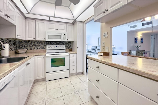 2800 N Atlantic Ave Unit 1716, Daytona Beach, FL 32118 - kitchen with white appliances, a sink, decorative backsplash, and light countertops