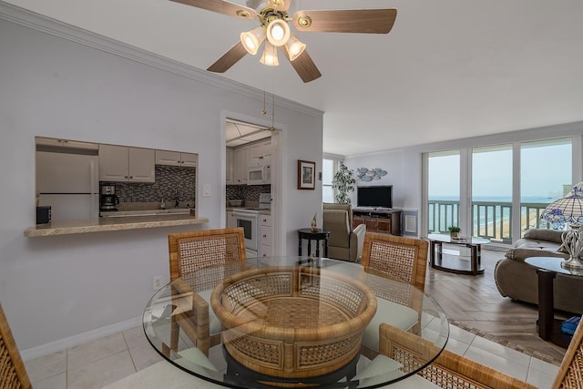 2800 N Atlantic Ave Unit 1716, Daytona Beach, FL 32118 - dining area with ceiling fan, crown molding, and baseboards
