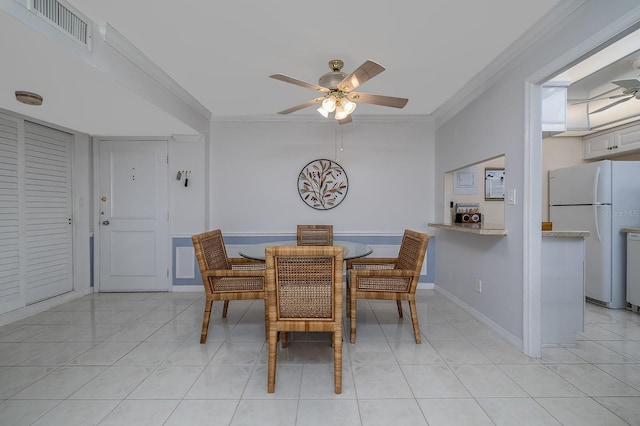 2800 N Atlantic Ave Unit 1716, Daytona Beach, FL 32118 - dining space with a ceiling fan, crown molding, light tile patterned floors, and baseboards