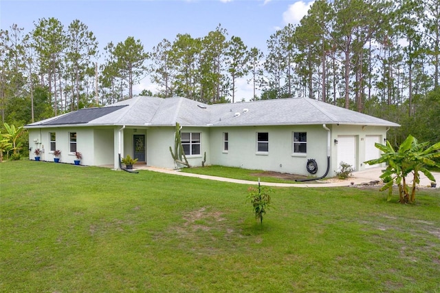 3671 Plantation Dr, Ormond Beach, FL 32174 - rear view of property with a garage, stucco siding, a yard, and driveway