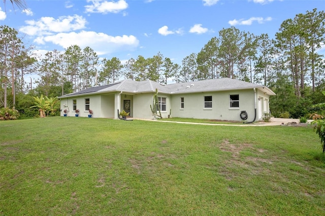 3671 Plantation Dr, Ormond Beach, FL 32174 - back of house featuring stucco siding, a yard, and an attached garage