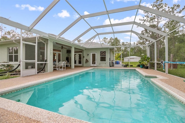 3671 Plantation Dr, Ormond Beach, FL 32174 - swimming pool featuring french doors, a patio area, a ceiling fan, and a lanai