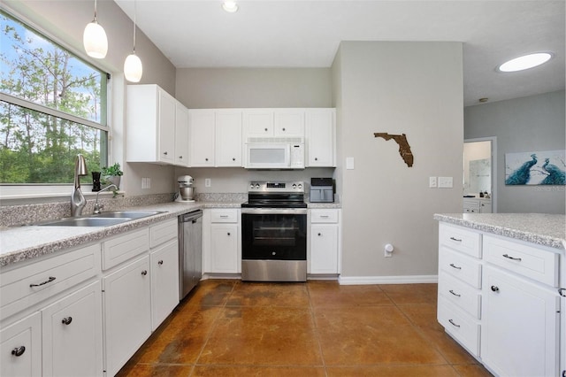 3671 Plantation Dr, Ormond Beach, FL 32174 - kitchen with appliances with stainless steel finishes, white cabinetry, and light countertops