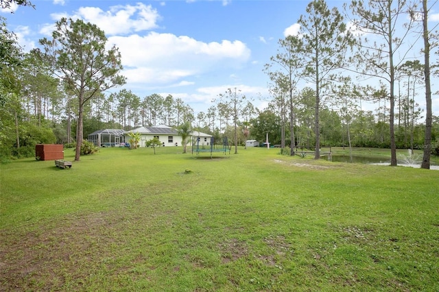 3671 Plantation Dr, Ormond Beach, FL 32174 - view of green lawn featuring a trampoline and a water view