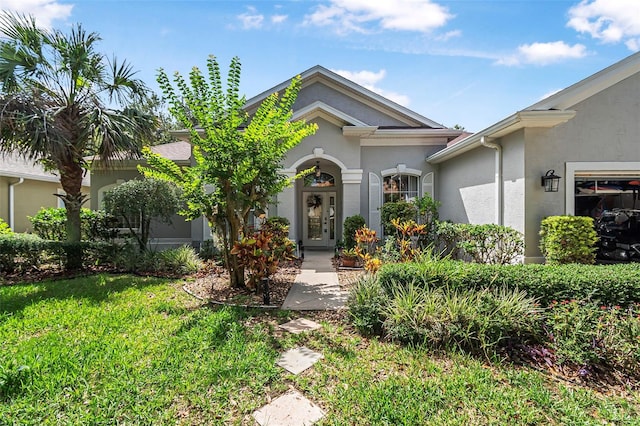 45 Saint Andrews Ct, Palm Coast, FL 32137 - view of front of house featuring stucco siding and a front yard