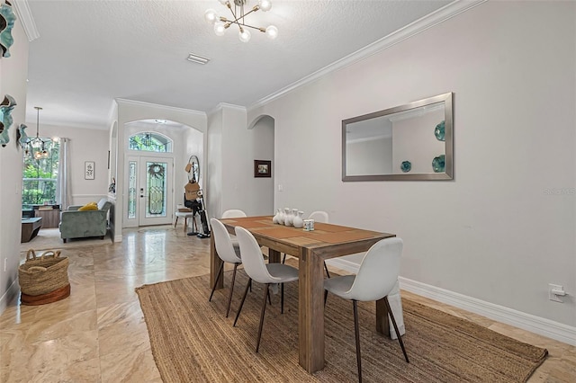45 Saint Andrews Ct, Palm Coast, FL 32137 - dining space with a chandelier, arched walkways, ornamental molding, light marble finish floors, and a textured ceiling