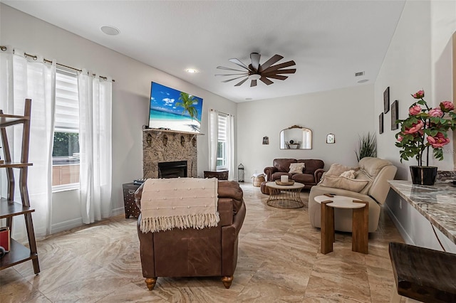 45 Saint Andrews Ct, Palm Coast, FL 32137 - living area with plenty of natural light, a ceiling fan, a fireplace, and light marble finish flooring