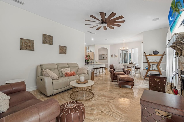 45 Saint Andrews Ct, Palm Coast, FL 32137 - living room with light marble finish floors, a ceiling fan, arched walkways, and a chandelier