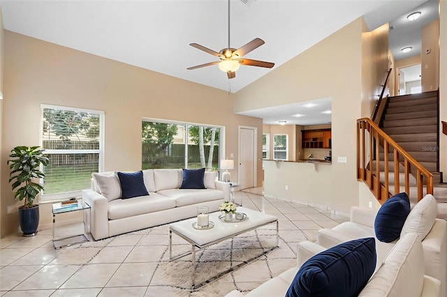 2708 Smithfield Dr, Orlando, FL 32837 - living area featuring light tile patterned flooring, a ceiling fan, stairway, high vaulted ceiling, and baseboards