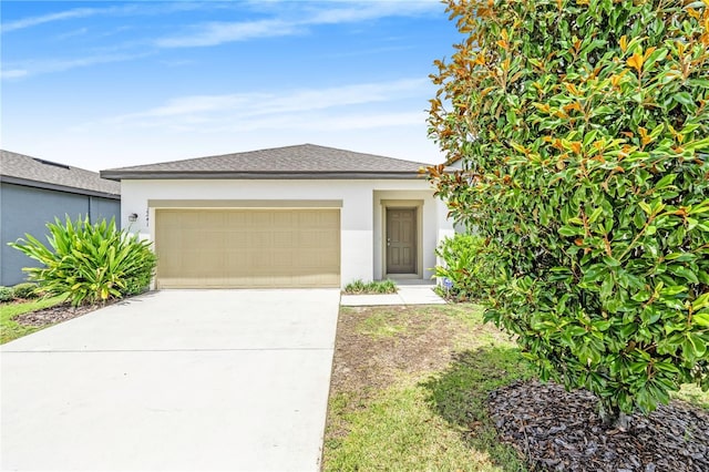 2241 Litchfield Loop, Deland, FL 32720 - view of front of house featuring a garage, stucco siding, and concrete driveway
