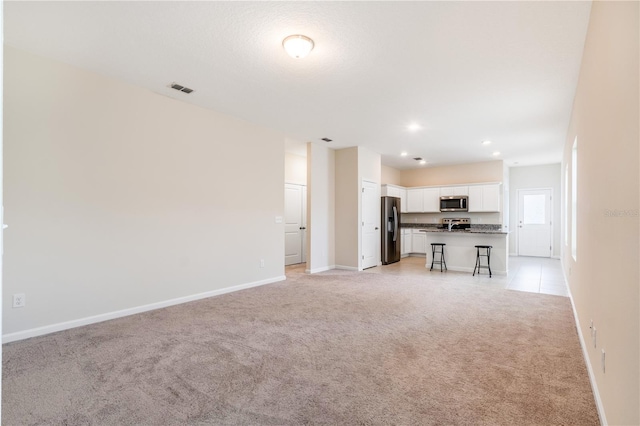2241 Litchfield Loop, Deland, FL 32720 - unfurnished living room with light colored carpet and recessed lighting