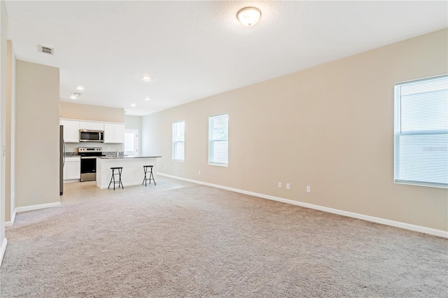 2241 Litchfield Loop, Deland, FL 32720 - unfurnished living room featuring light carpet and recessed lighting