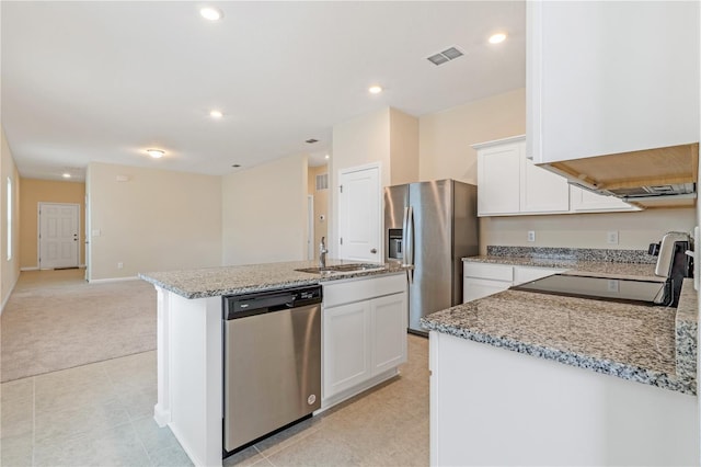 2241 Litchfield Loop, Deland, FL 32720 - kitchen with appliances with stainless steel finishes, light stone counters, white cabinets, a center island with sink, and recessed lighting