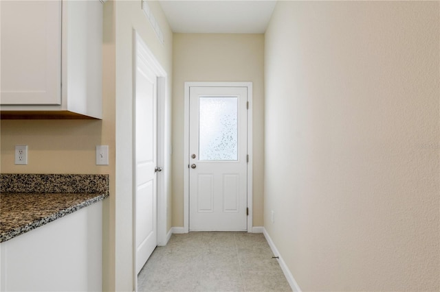 2241 Litchfield Loop, Deland, FL 32720 - doorway to outside featuring baseboards