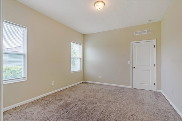 2241 Litchfield Loop, Deland, FL 32720 - empty room with healthy amount of natural light and carpet flooring