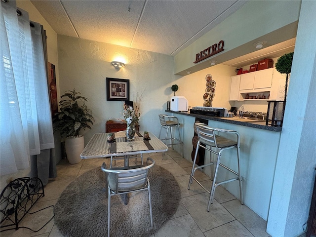 411 N Halifax Ave Unit 208, Daytona Beach, FL 32118 - dining space with light tile patterned flooring and a textured ceiling