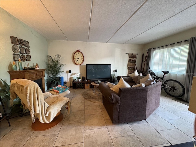 411 N Halifax Ave Unit 208, Daytona Beach, FL 32118 - living room featuring a textured ceiling, light tile patterned flooring, and a fireplace