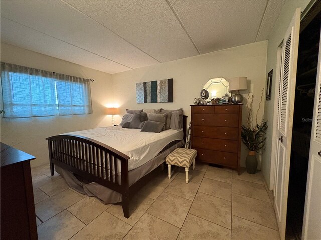 411 N Halifax Ave Unit 208, Daytona Beach, FL 32118 - bedroom with a textured ceiling and light tile patterned floors