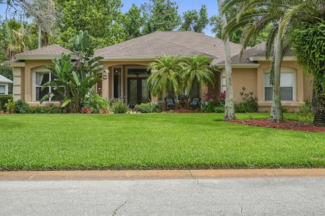 33 Coquina Ridge Way, Ormond Beach, FL 32174 - view of front of house featuring stucco siding, a front yard, and a shingled roof