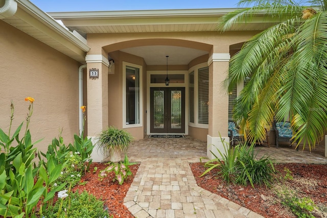 33 Coquina Ridge Way, Ormond Beach, FL 32174 - doorway to property with french doors and stucco siding