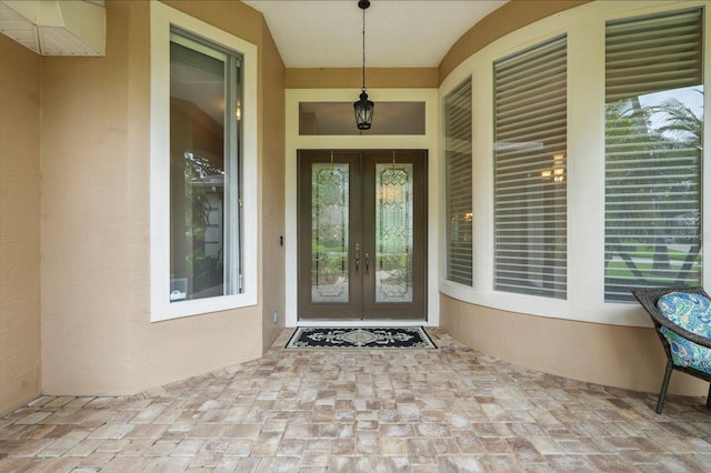 33 Coquina Ridge Way, Ormond Beach, FL 32174 - view of exterior entry featuring french doors and stucco siding