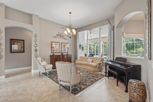 33 Coquina Ridge Way, Ormond Beach, FL 32174 - living area featuring arched walkways, a chandelier, and light tile patterned floors