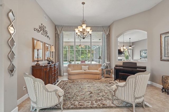 33 Coquina Ridge Way, Ormond Beach, FL 32174 - tiled living area with a chandelier, arched walkways, and baseboards