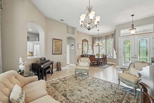 33 Coquina Ridge Way, Ormond Beach, FL 32174 - living area featuring arched walkways, a chandelier, baseboards, light tile patterned floors, and french doors