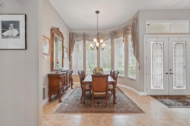 33 Coquina Ridge Way, Ormond Beach, FL 32174 - dining area with a chandelier, baseboards, light tile patterned floors, and french doors
