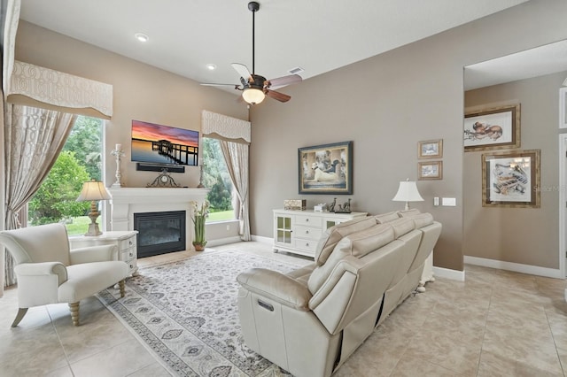 33 Coquina Ridge Way, Ormond Beach, FL 32174 - living room with baseboards, ceiling fan, a glass covered fireplace, light tile patterned floors, and recessed lighting