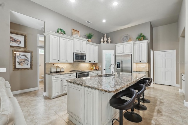 33 Coquina Ridge Way, Ormond Beach, FL 32174 - kitchen featuring appliances with stainless steel finishes, a sink, baseboards, decorative backsplash, and recessed lighting