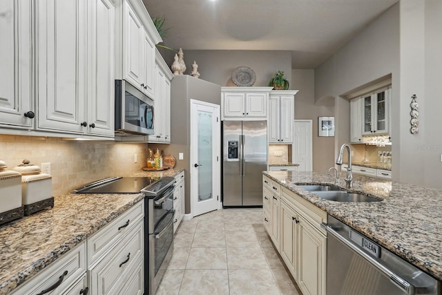 33 Coquina Ridge Way, Ormond Beach, FL 32174 - kitchen featuring stainless steel appliances, a sink, tasteful backsplash, and light stone countertops
