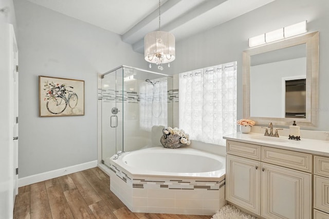33 Coquina Ridge Way, Ormond Beach, FL 32174 - full bathroom with a bath, vanity, a stall shower, a chandelier, and wood finished floors