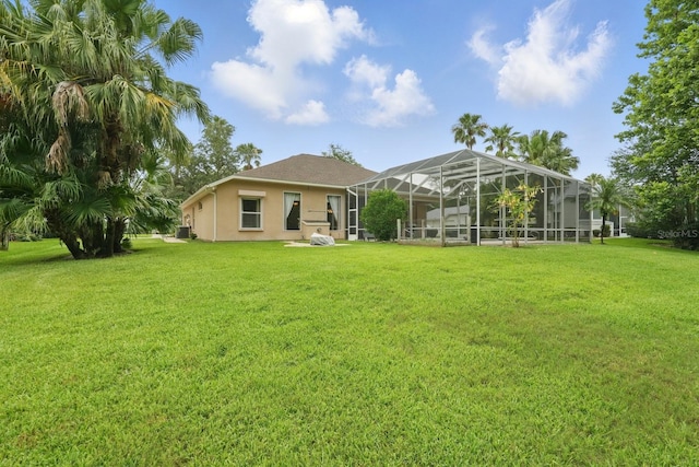 33 Coquina Ridge Way, Ormond Beach, FL 32174 - rear view of property with a lawn, stucco siding, and a lanai