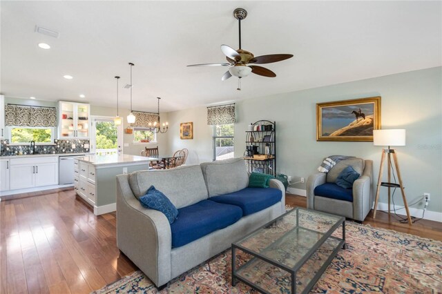 2250 Davis Dr, New Smyrna Beach, FL 32168 - living room with a ceiling fan, a chandelier, wood finished floors, and recessed lighting