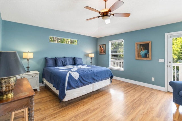 2250 Davis Dr, New Smyrna Beach, FL 32168 - bedroom featuring access to exterior, multiple windows, and light wood-type flooring